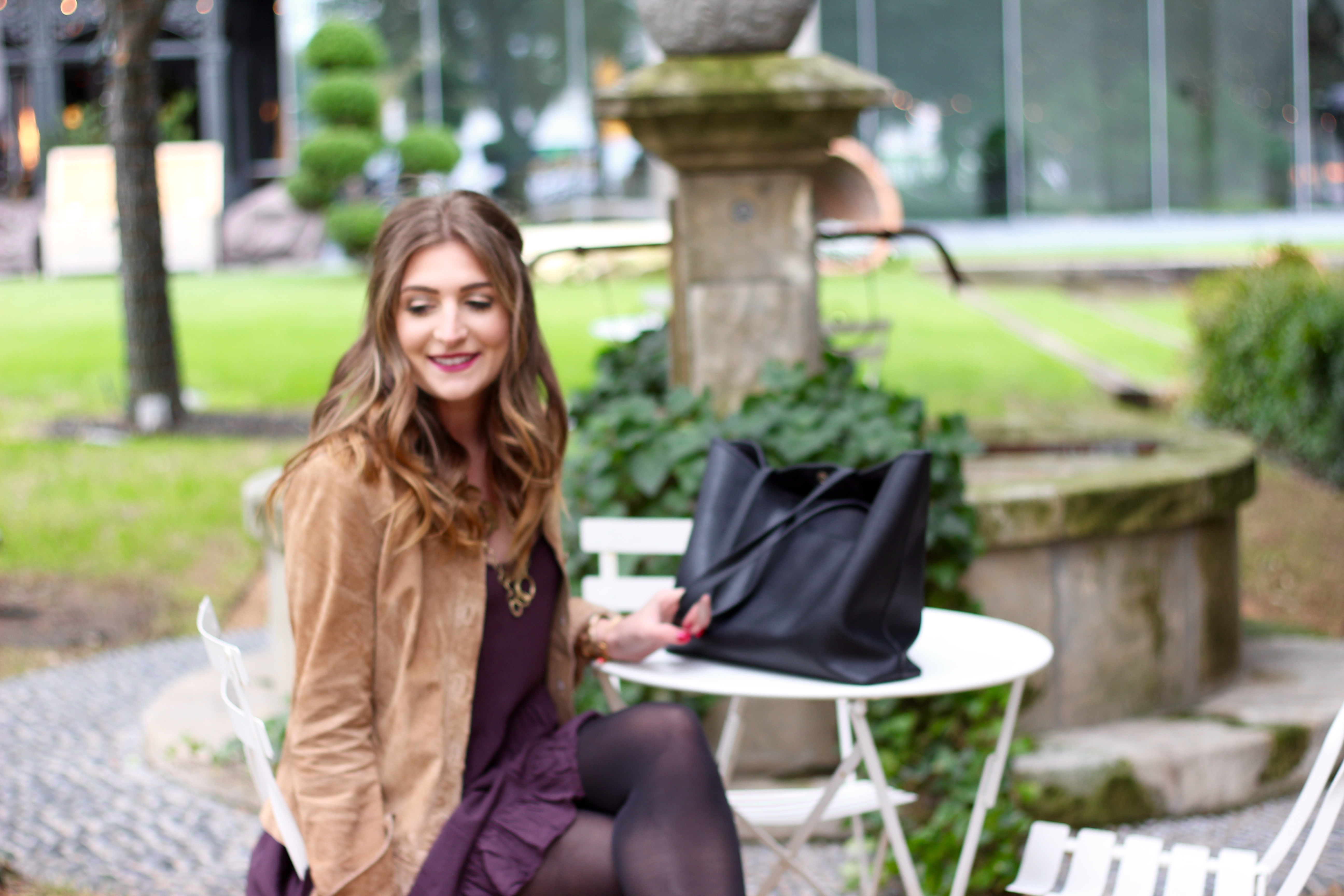 sitting in a courtyard in a flowy dress