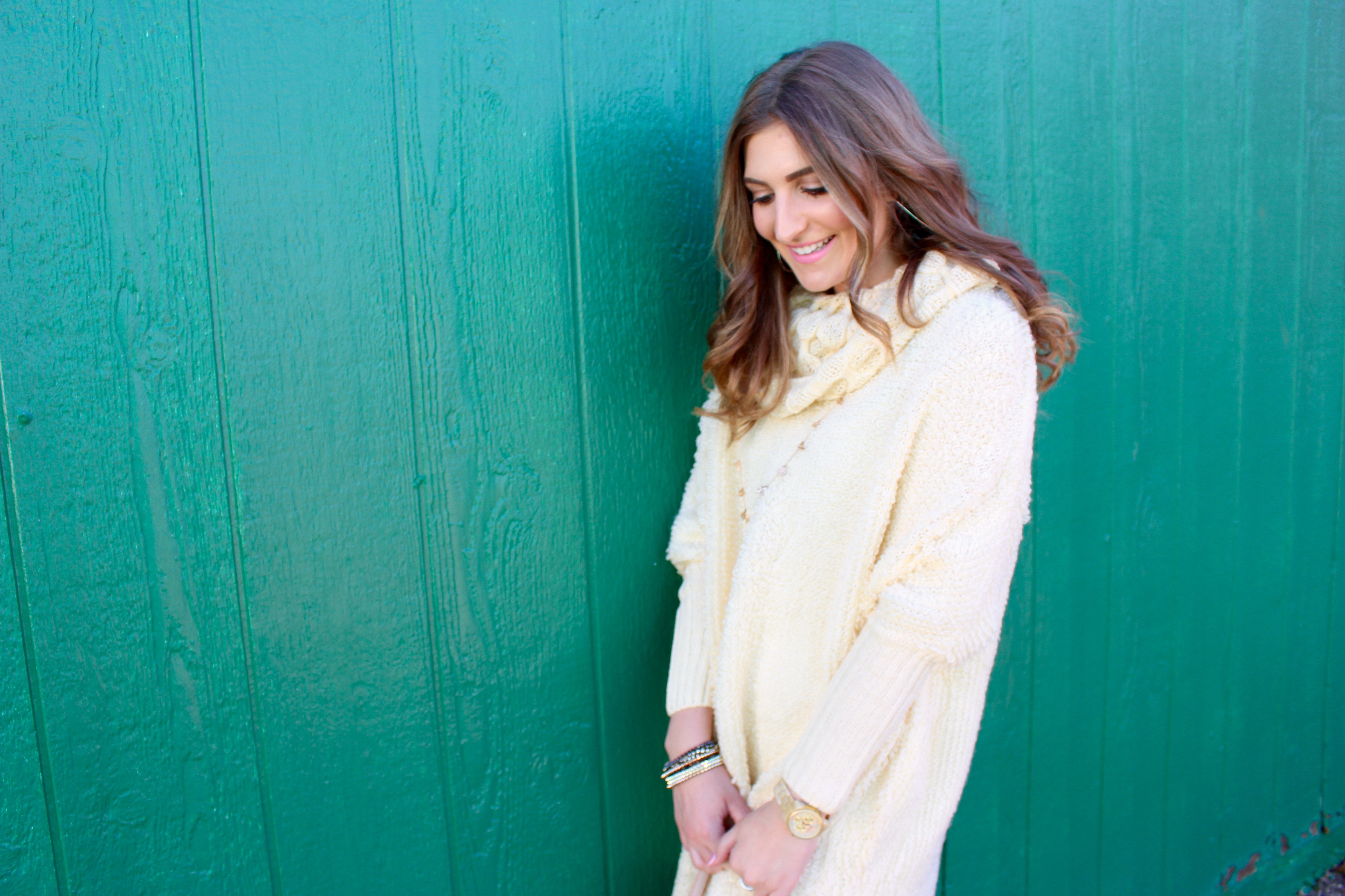 green wall and cream dress