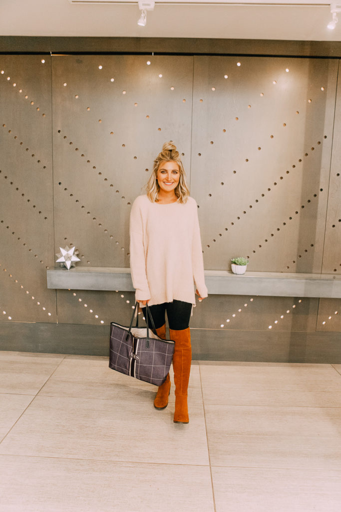 How To Style Leggings For Work featured by top US fashion blogger Audrey Madison Stowe; Image of a woman wearing a Red Dress over-sized sweater and OTK boots.