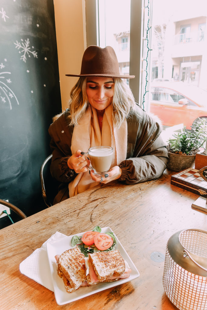 Santa Fe Weekend featured by top US travel blogger Audrey Madison Stowe; Image of woman drinking a cup of coffee.