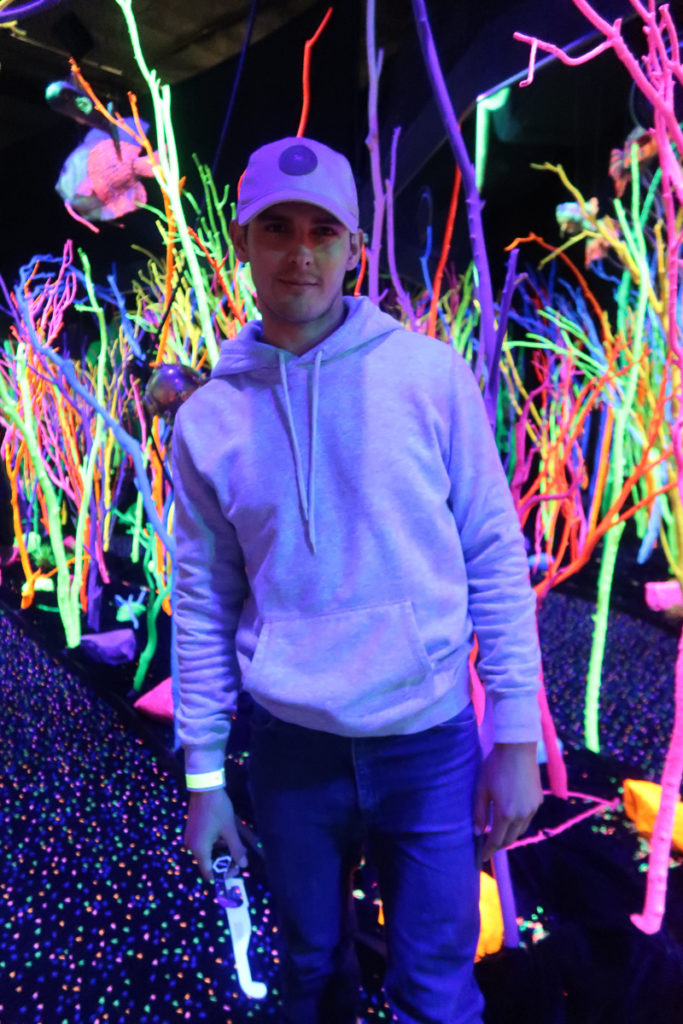 Santa Fe Weekend featured by top US travel blogger Audrey Madison Stowe; Image of man in black light room.