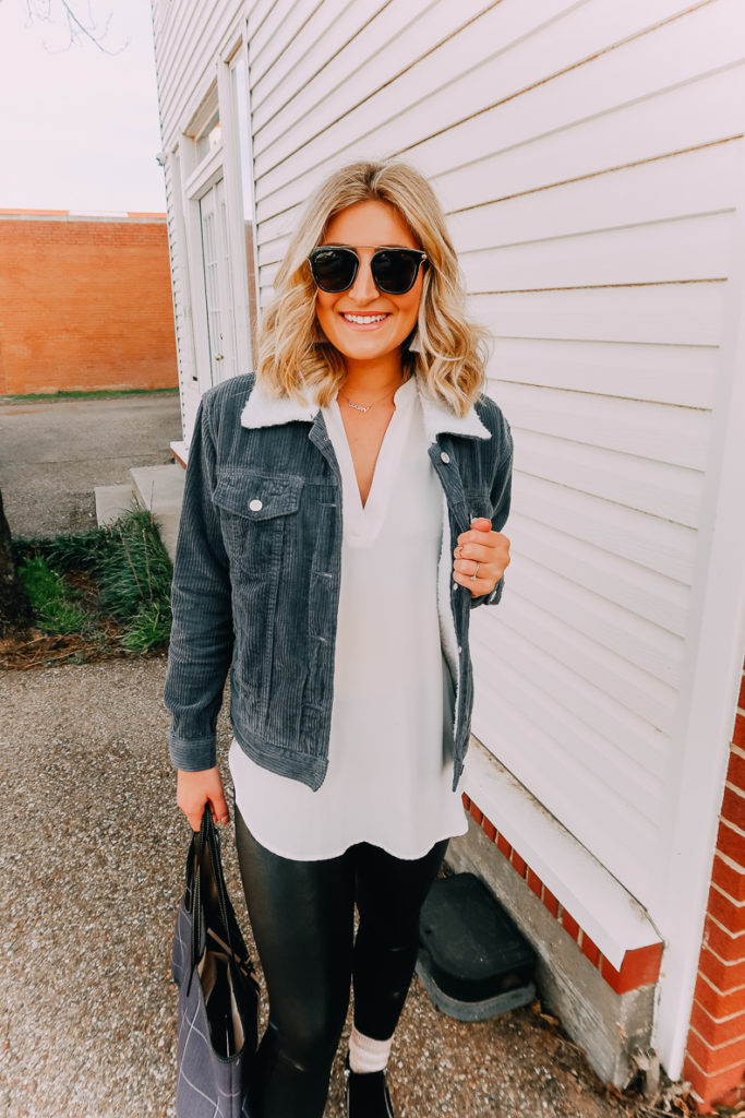 Ways To Wear a White Blouse featured by top US fashion blogger Audrey Madison Stowe; Image of woman wearing white blouse, denim jacket, faux leather leggings and Steve Madden wedges.