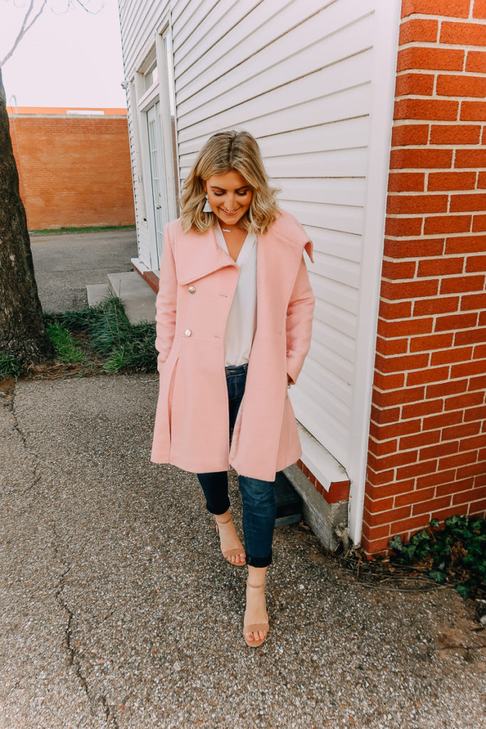 Ways To Wear a White Blouse featured by top US fashion blogger Audrey Madison Stowe; Image of woman wearing white blouse, pink coat and nude heels.