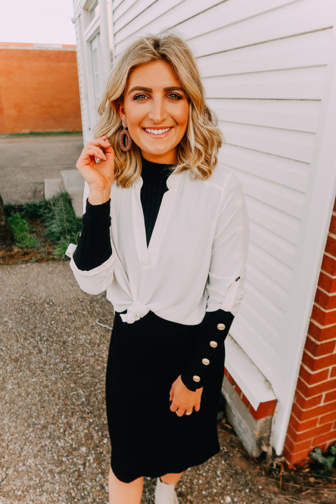 Ways To Wear a White Blouse featured by top US fashion blogger Audrey Madison Stowe; Image of woman wearing white blouse and black midi sweater dress.